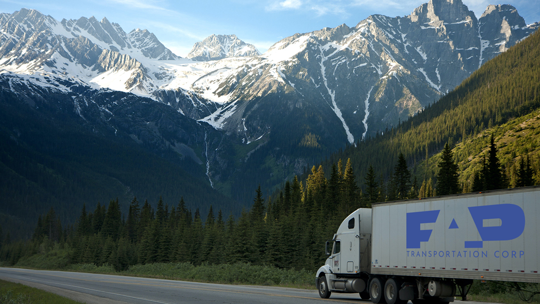 Fap Transportation Company truck on a mounatin road between with a wood in the background